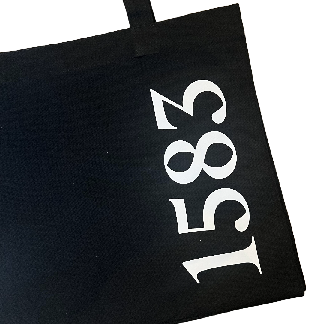 close up of 1583 print on black tote bag