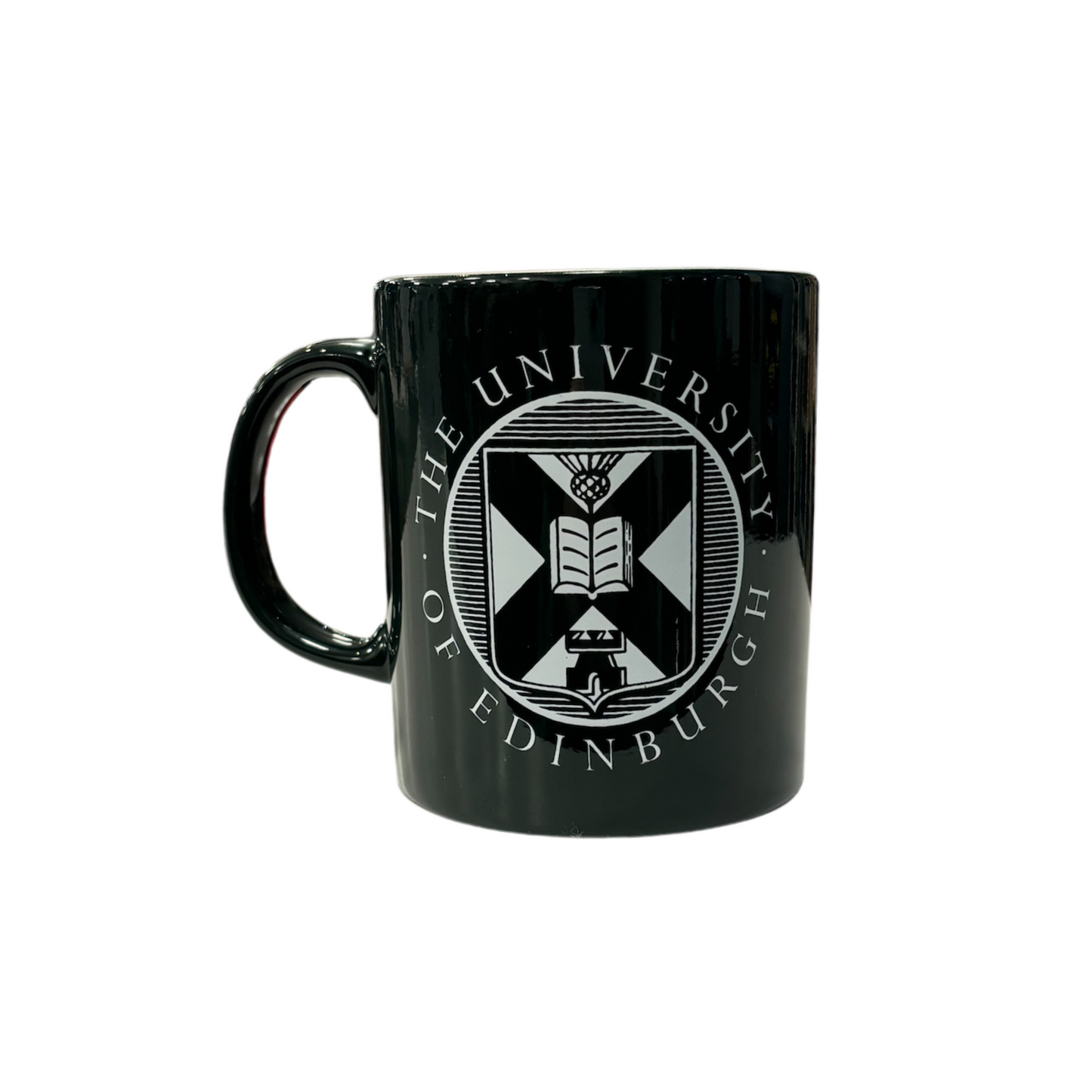 dark green mug with white University crest
