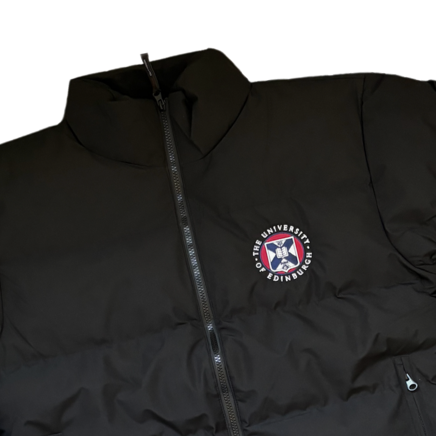 Full zip black puffer with collar, zip pockets, and adjustable cuffs. Features full colour university crest.