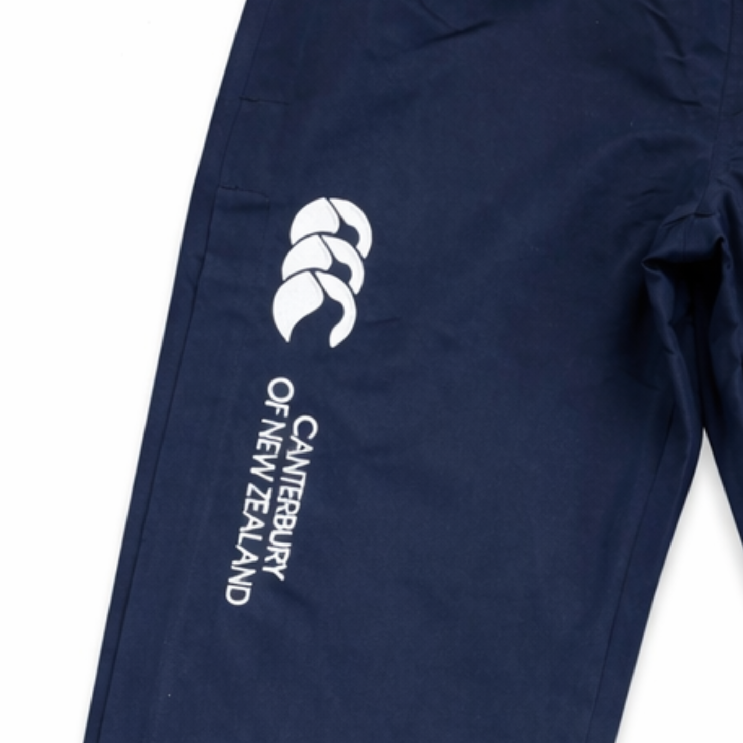 Close up o f navy blue pants with Canterbury of New Zealand logo.