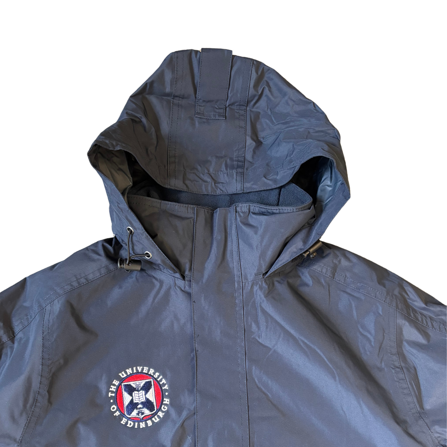 Close up of the embroidered crest, the jacket's fleece lining, convertible hood, and water resistant fabric.