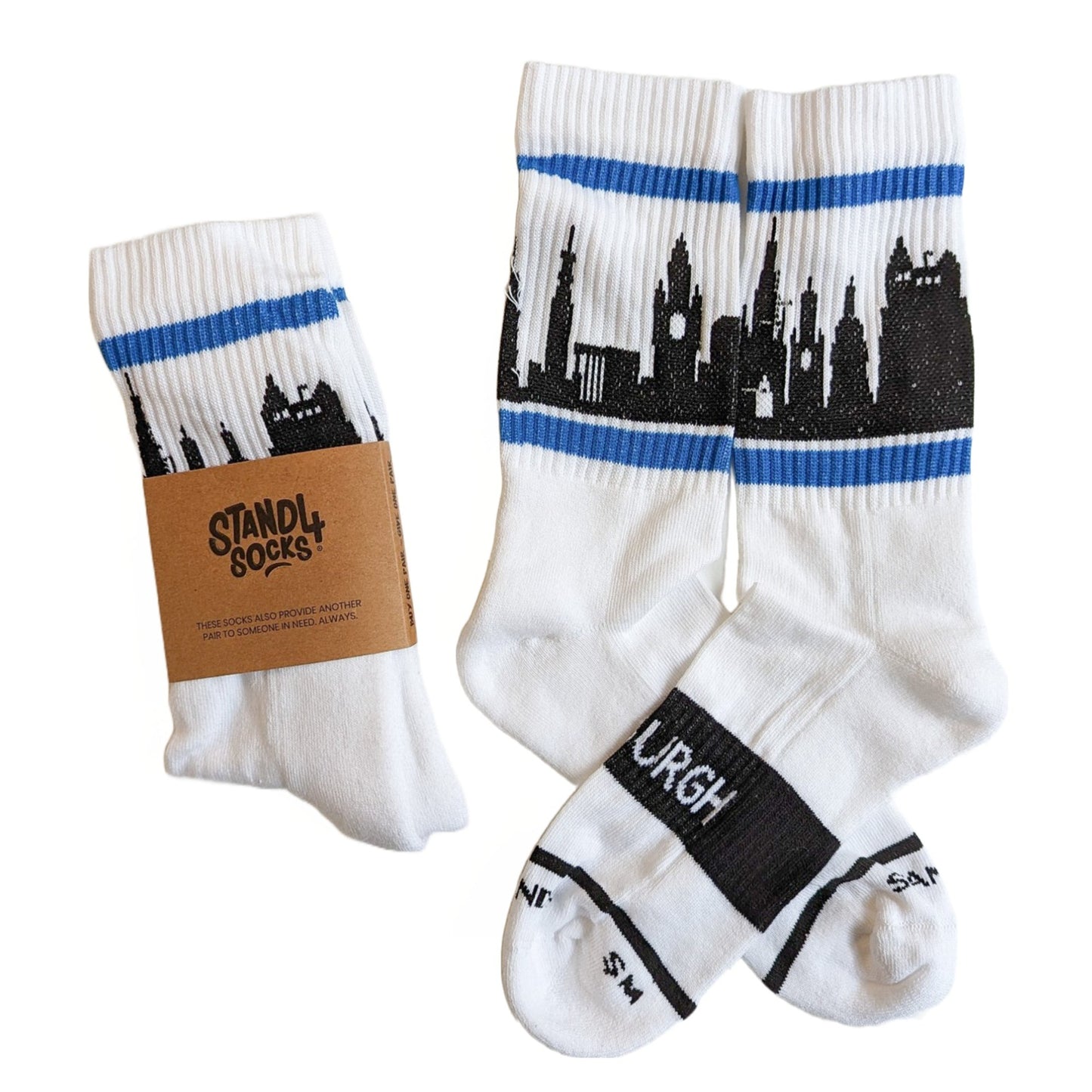 White ribbed crew socks with black silhouette of the Edinburgh skyline, bordered by a blue horizontal stripe. 