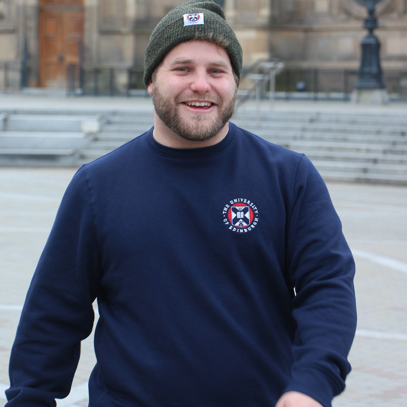 Model wears navy crew neck sweatshirt with the University crest embroidered on the breast in full colour embroidery.