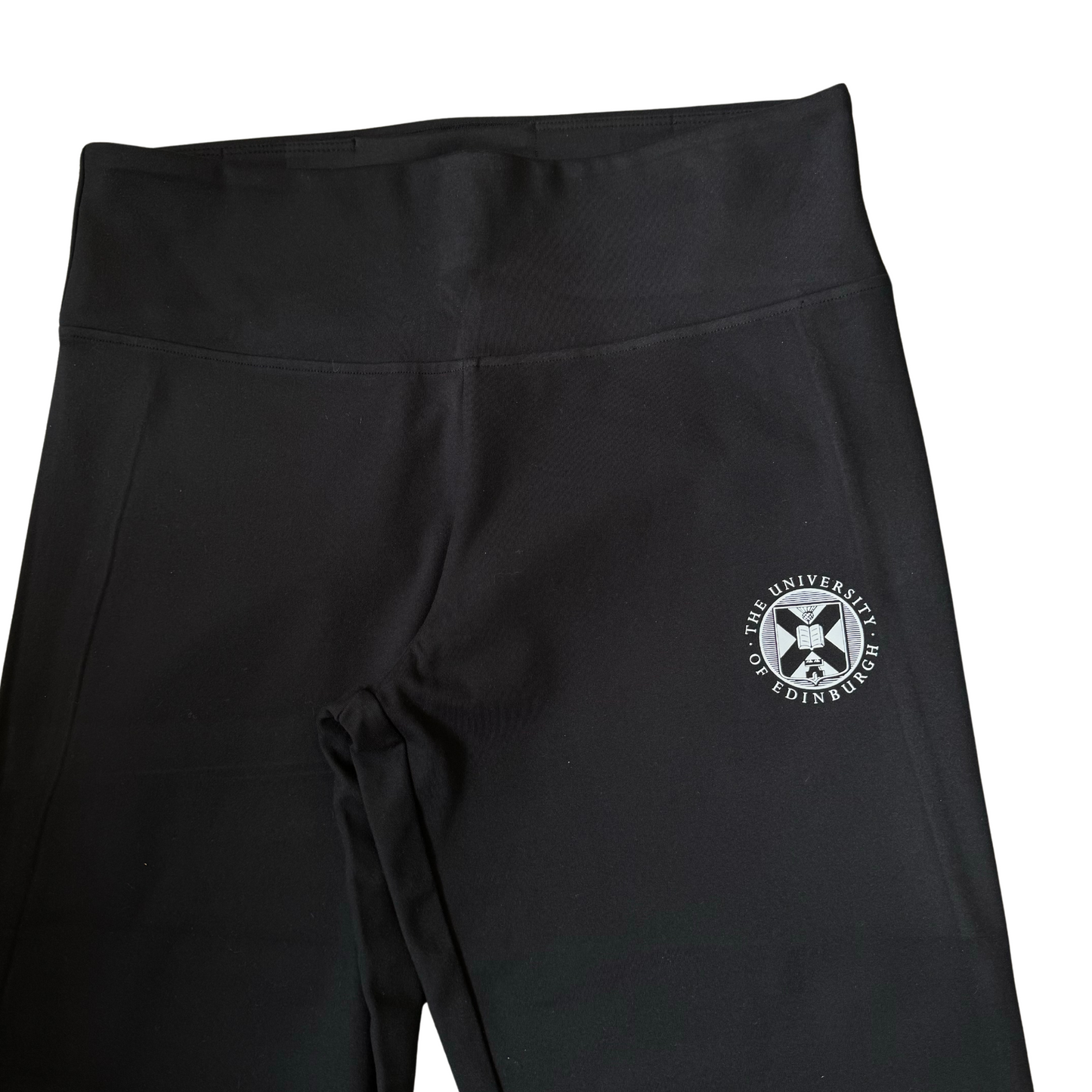 Close up of white University crest on right hip of flares.