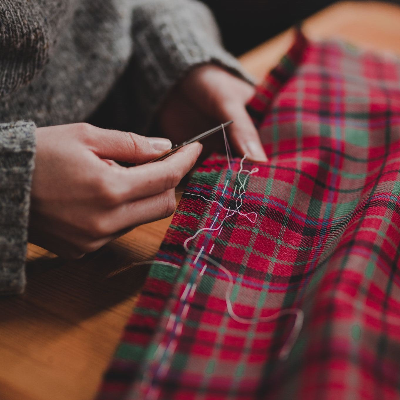 Hand-stitching tartan fabric