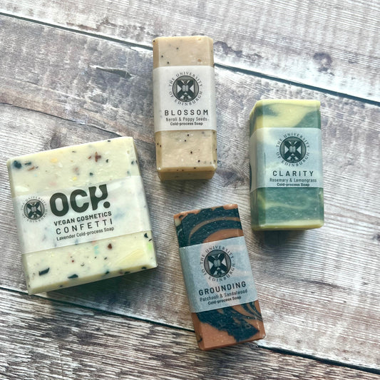 4 soaps arranged on a wood background
