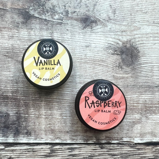 Vanilla and Raspberry lip balm tins featuring the University crest