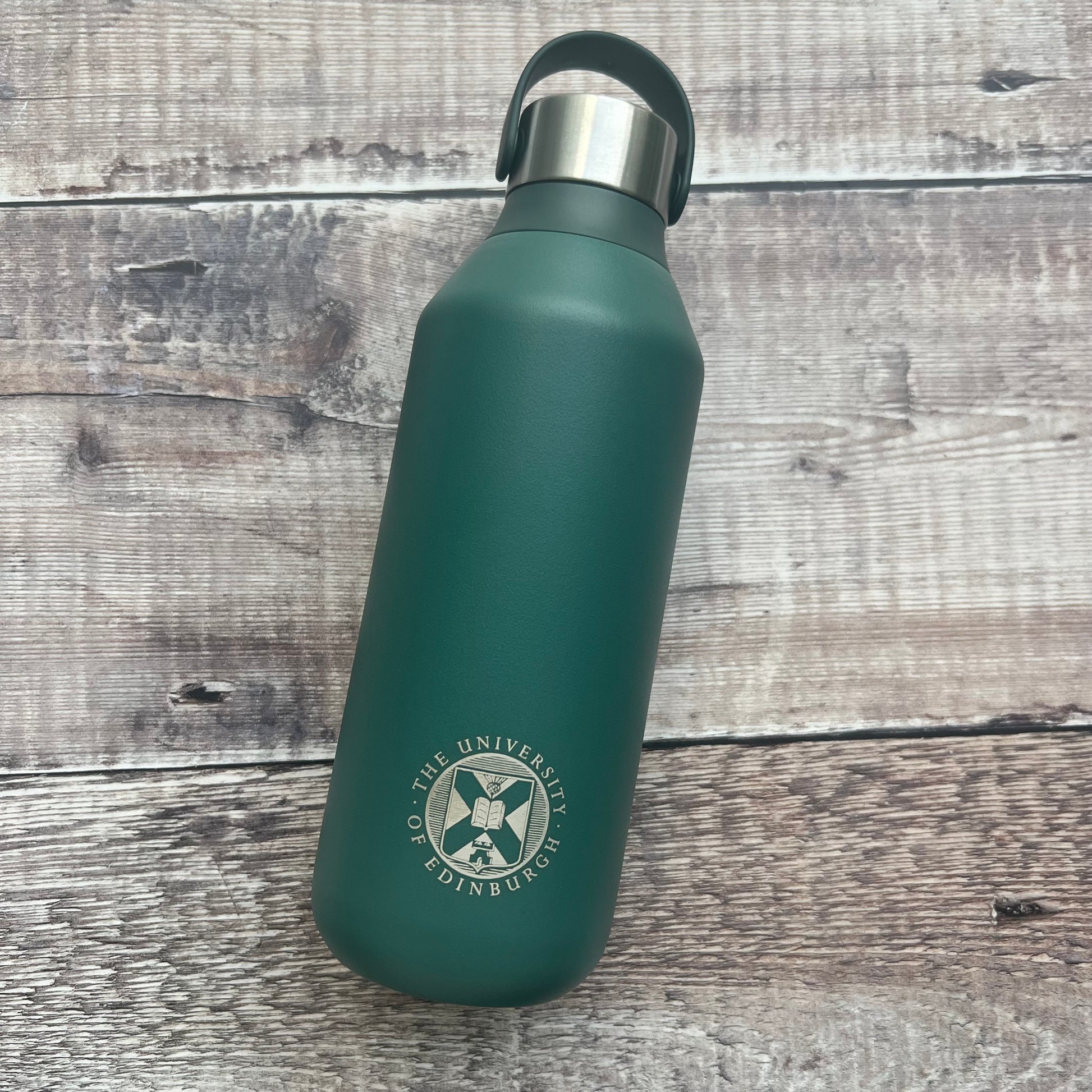 Green chillys bottle with the university crest engraved