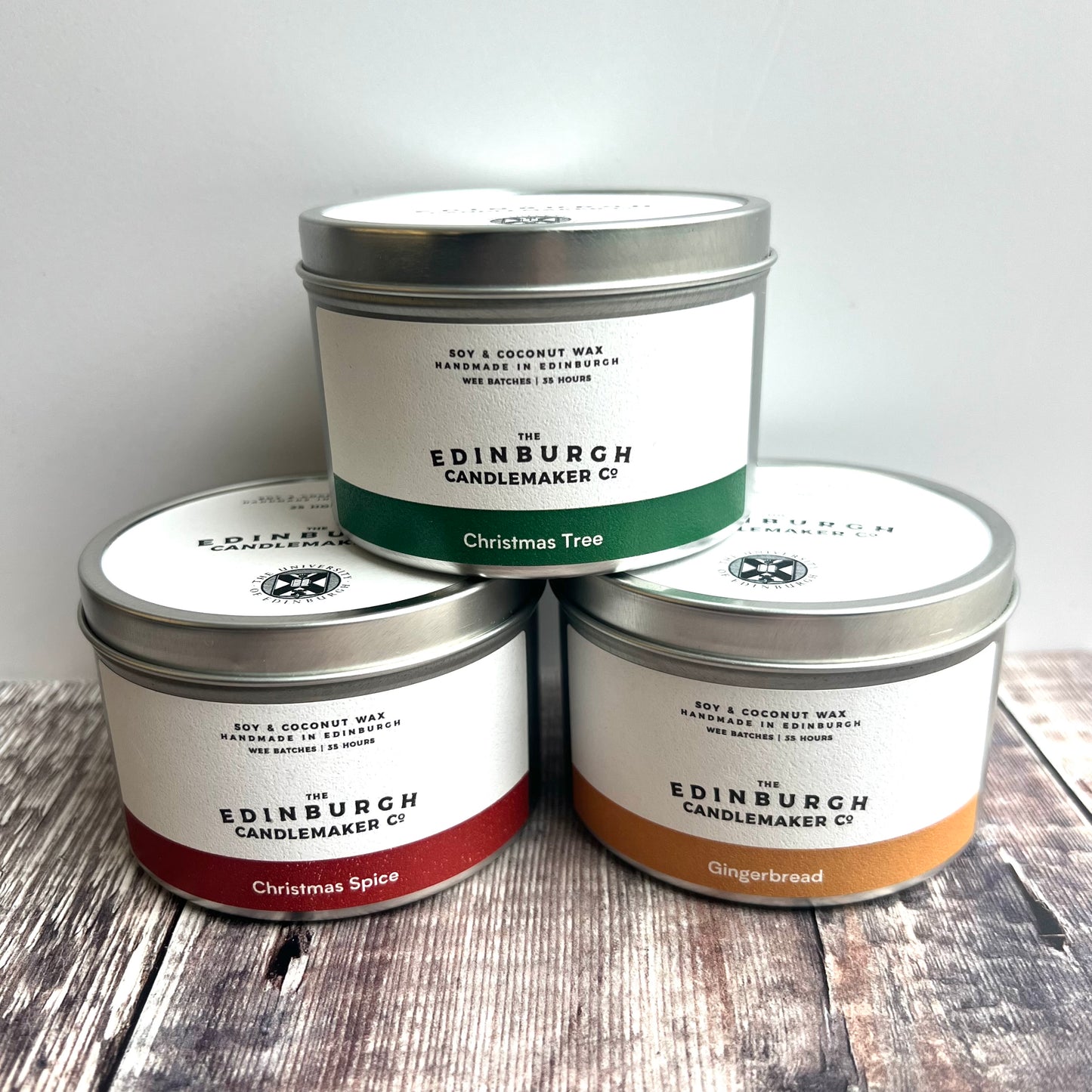 Christmas tree candle, christmas spice candel and gingerbread candle in silver tine with white labels.