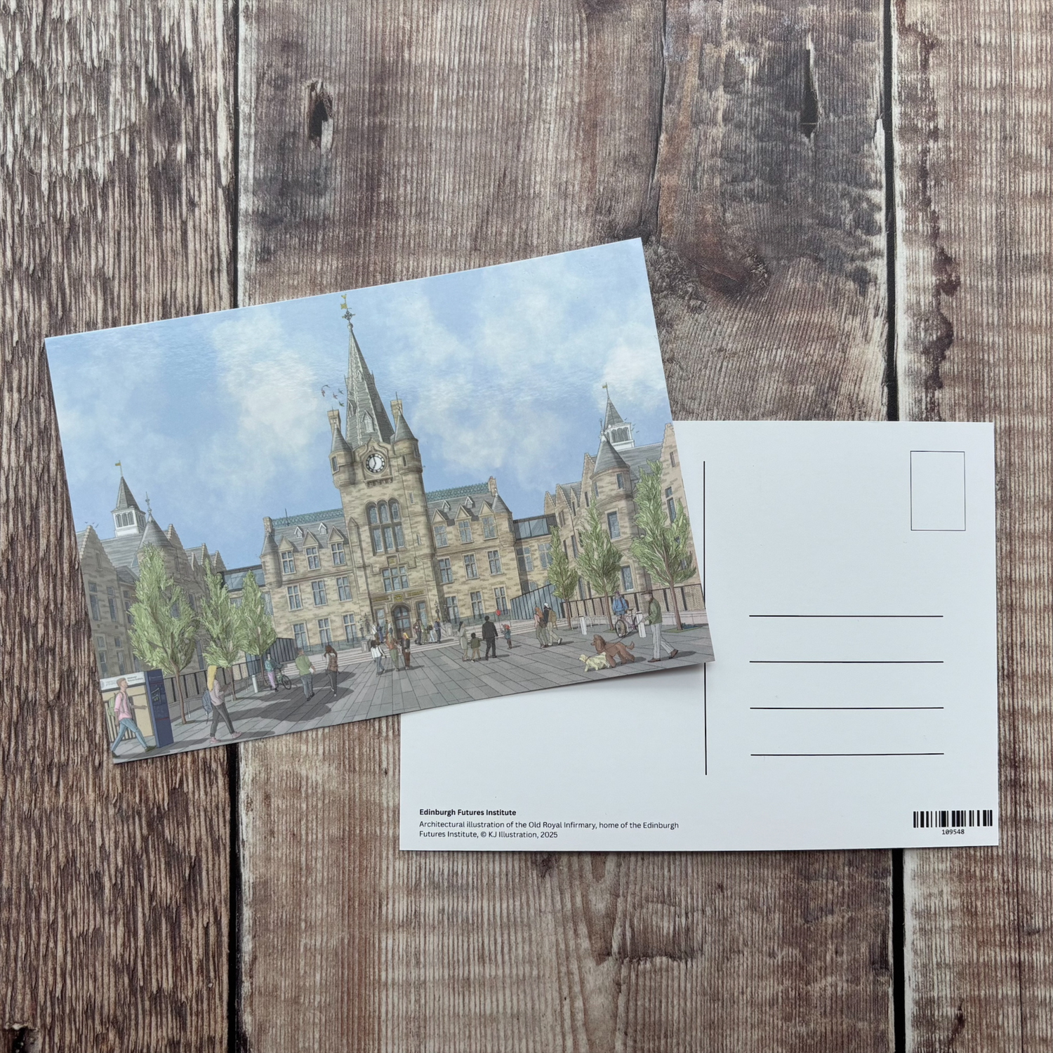 The front and back of the postcard against a wooden backdrop.