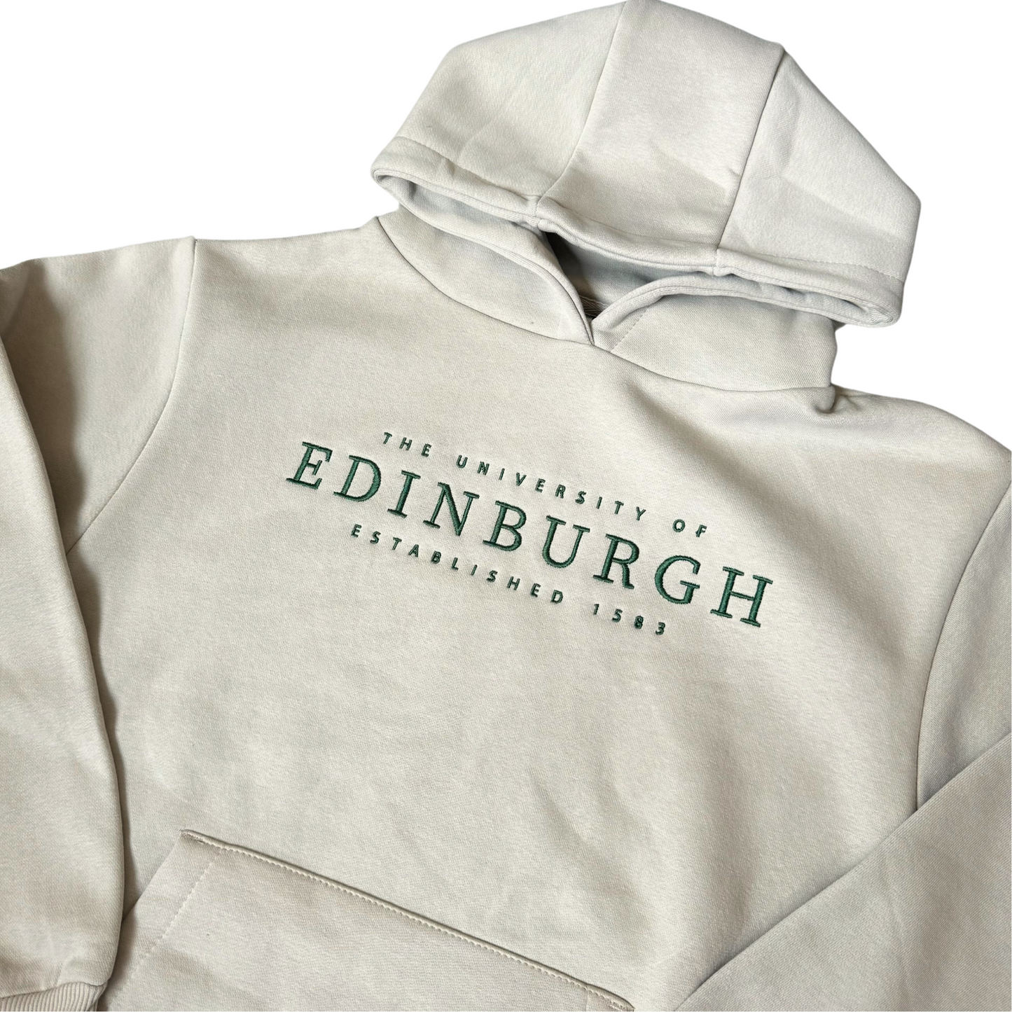 Close up of Stone Oversized Established Hoodie with green embroidered text reading 'The University of Edinburgh Established 1583'.