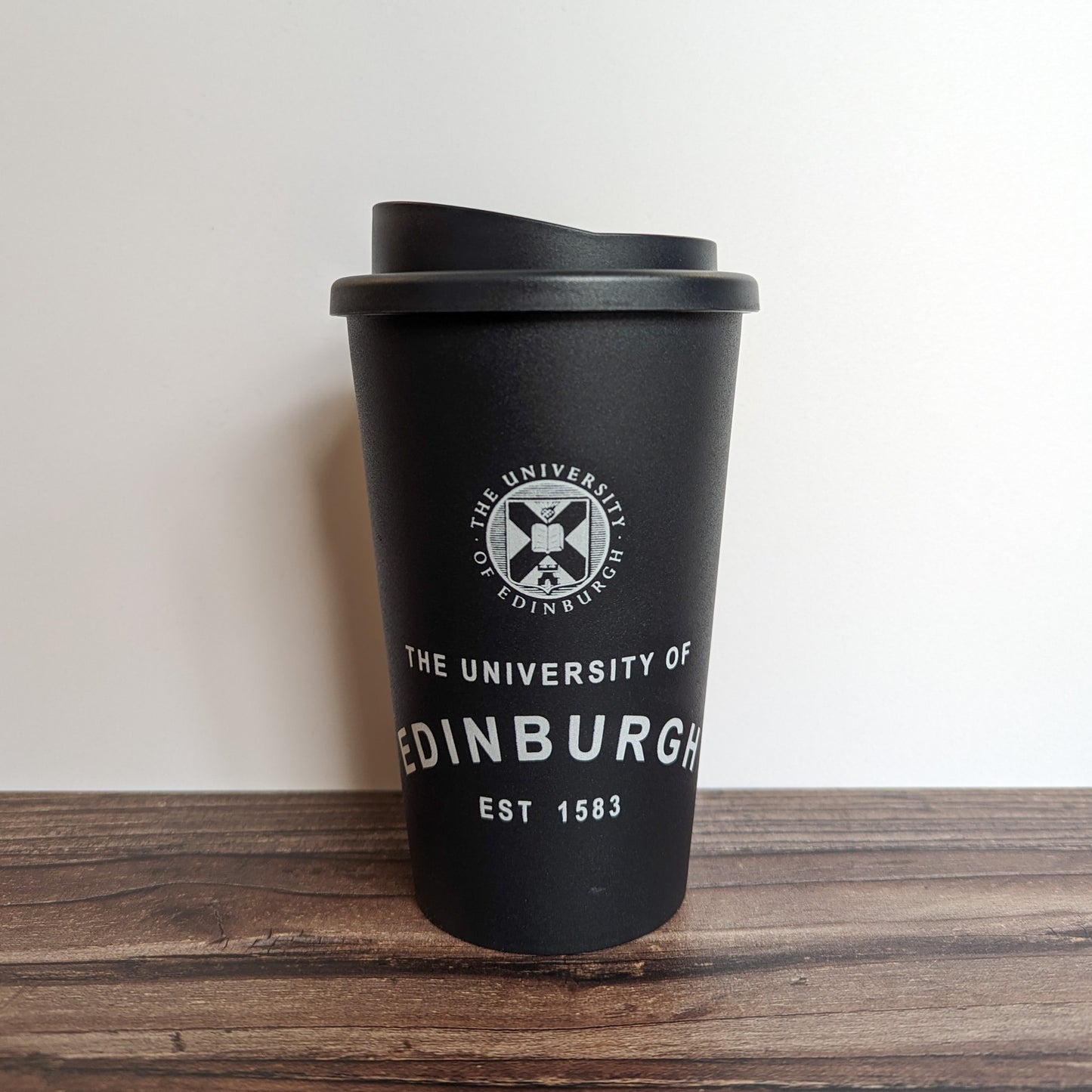 Eco Coffee Cup in Black, with the design in White.