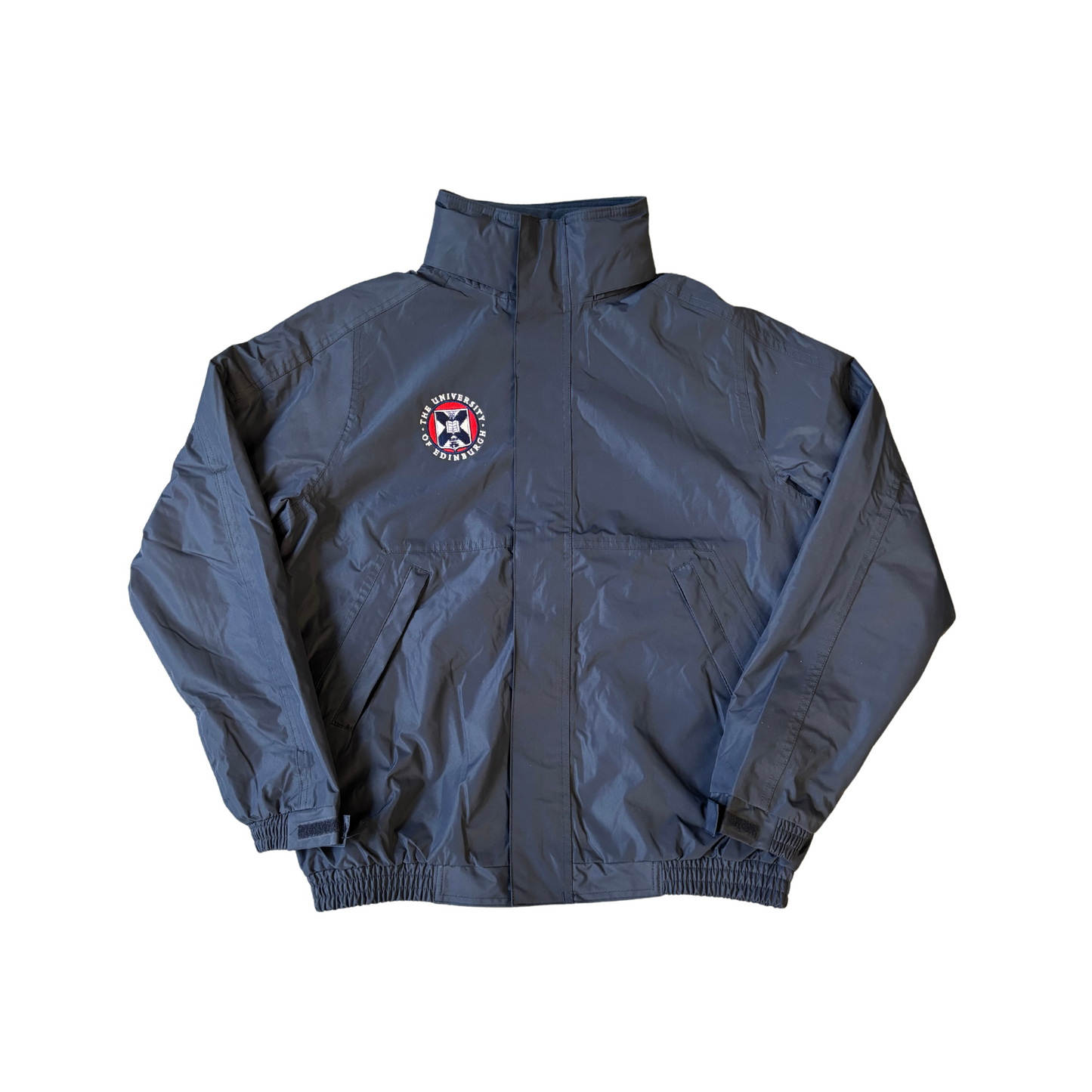 Our navy Premium Outdoor Jacket features a University Crest over the left chest, a high collar, elasticized cuffs and waistband, zipped pockets and a front zipper closure concealed by a protective flap.