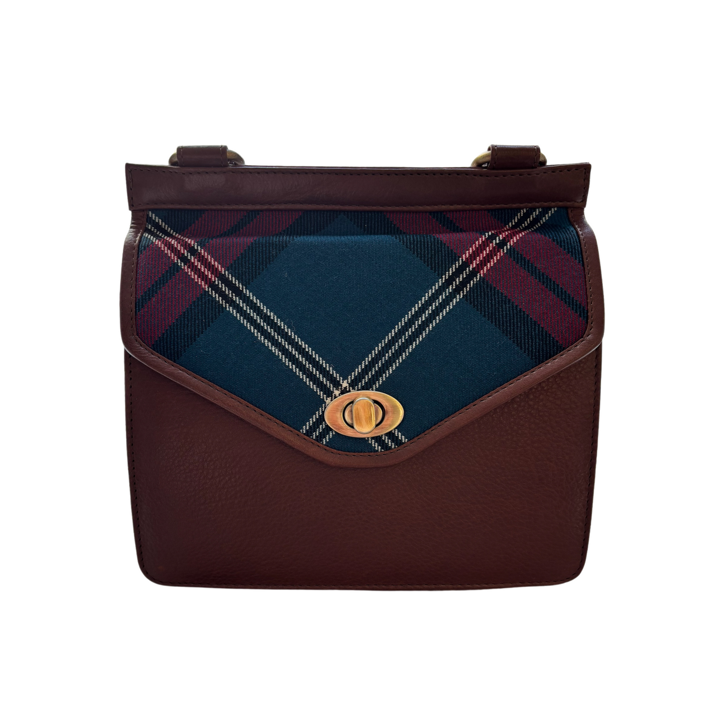 Pictured is the front of the Tartan and Leather Crossbody bag. The bag is brown leather with a tartan flap. The bag features a metal closure made of gold hardware.