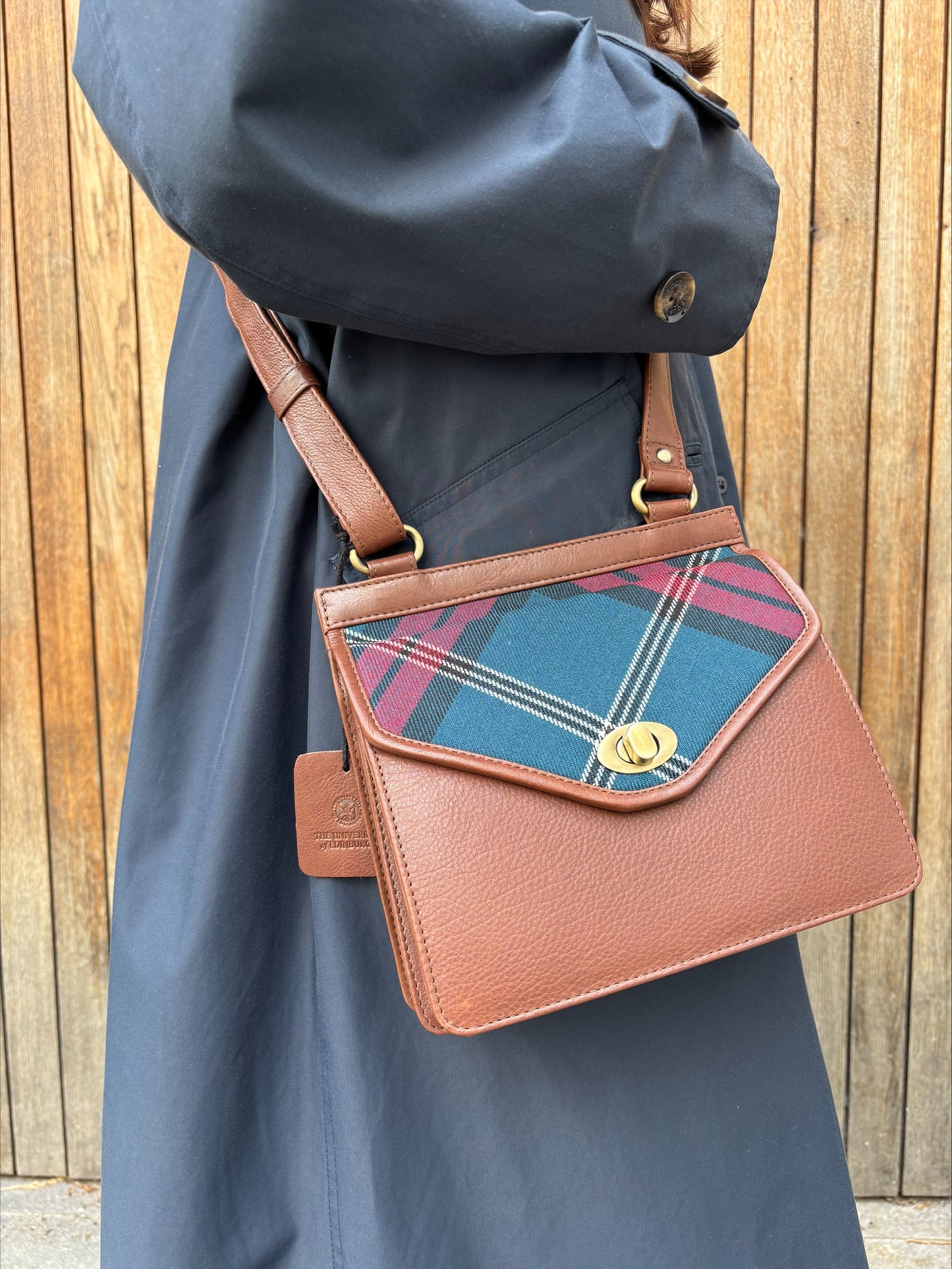 Models is pictured wearing the Tartan and Leather Crossbody Bag.