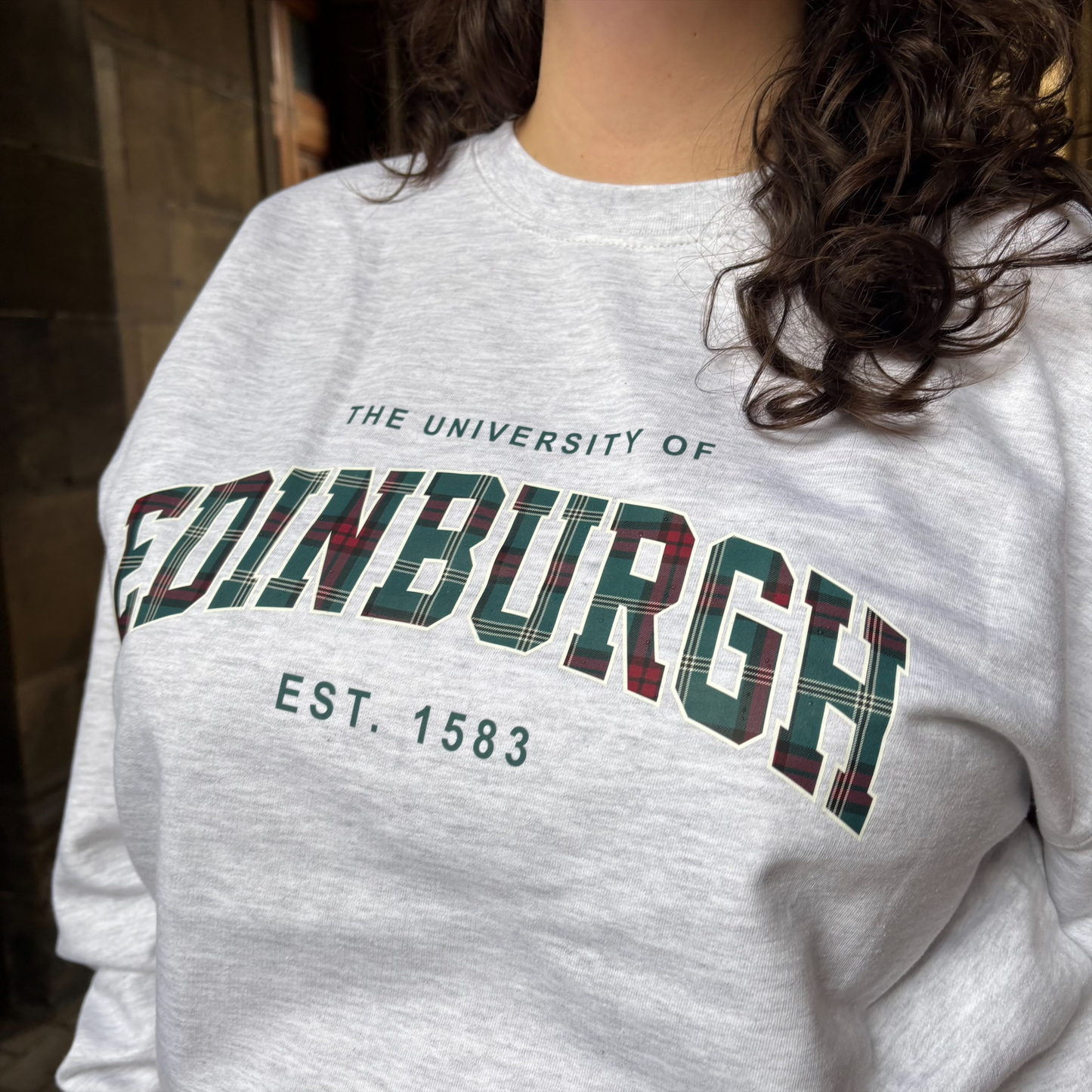Close up of our tartan print design against the ash grey sweatshirt.