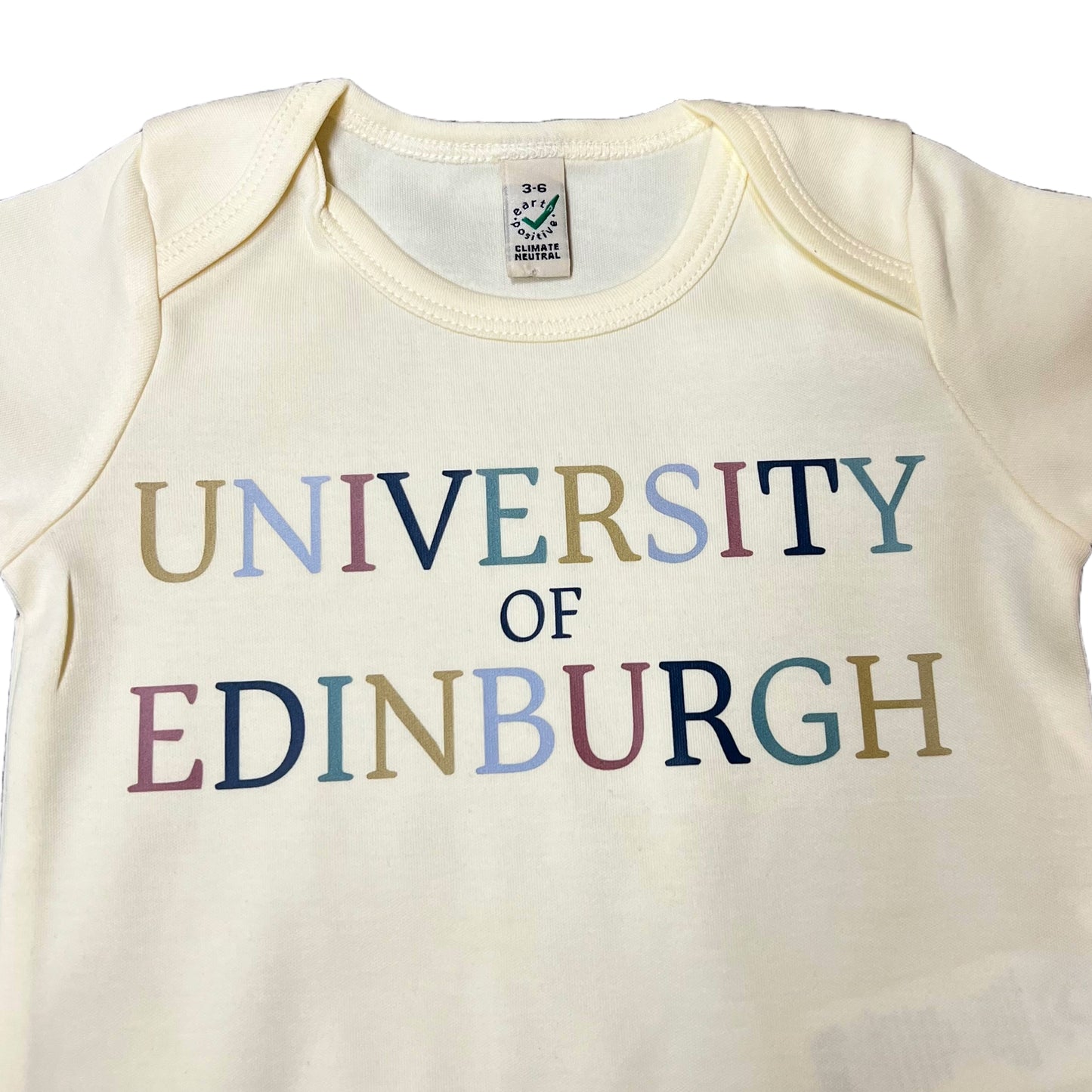 Colourful Kids babygrow in Ecru (Sandy White). Text reads 'University of Edinburgh' in colourful lettering.