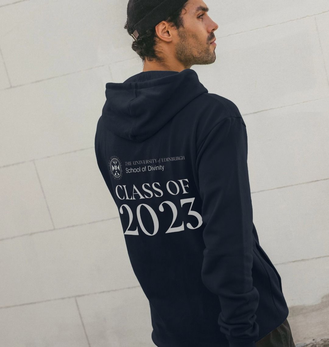 Model wears Navy School of Divinity 'Class Of' Graduate Hoodie showing back design.