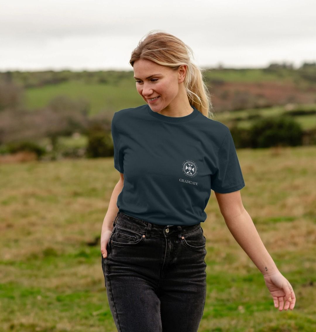 Model wears Graduate Small Crest T-Shirt in colour Dark Grey. 