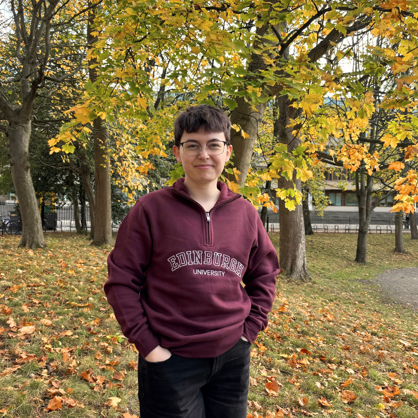 Model wears Varsity 1/4 Zip Sweatshirt in George Square Garden.