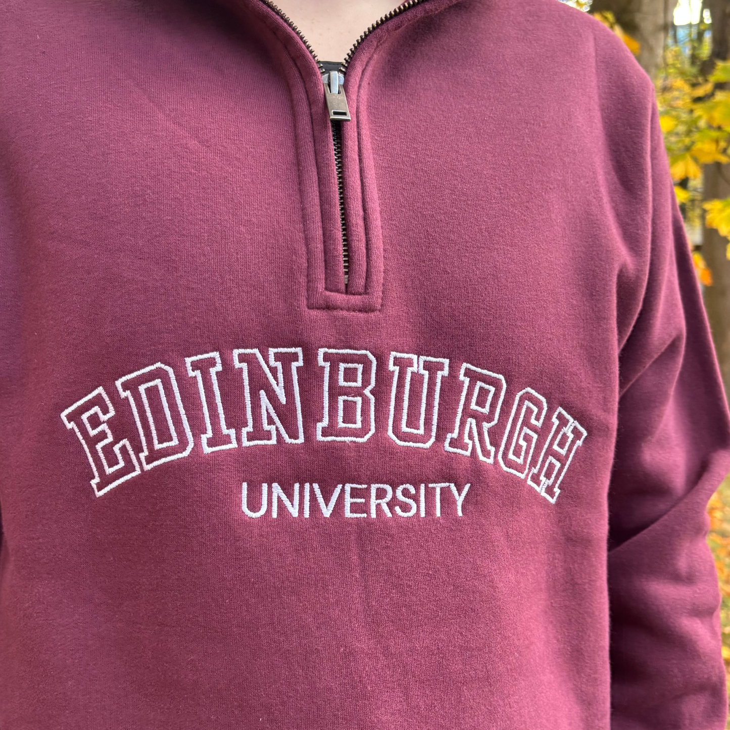 White embroidery detail on the varsity quarterip zip sweatshirt.