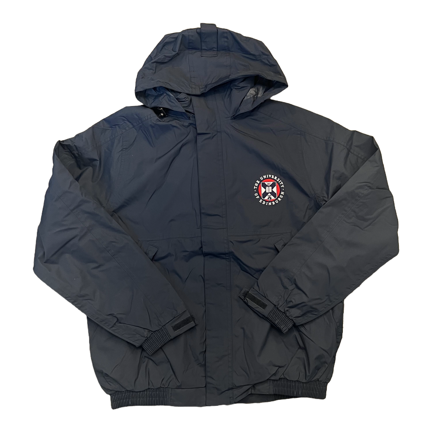 navy waterproof jacket with hood up, with the University crest embroidered on the left chest in white, red and navy