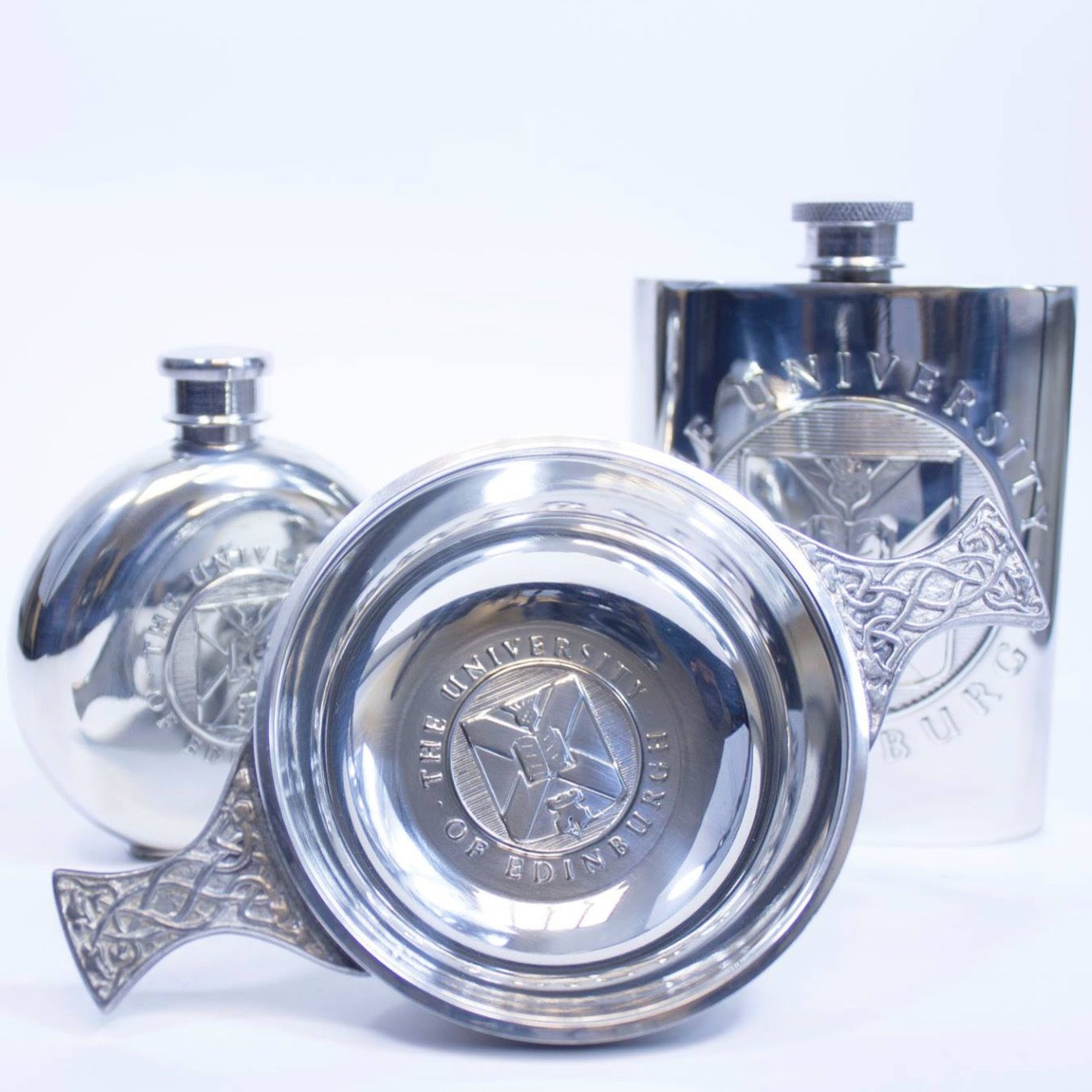 The items in the pewter gift range - round pewter hipflask on the left, quaich in the middle and square hipflask on the right