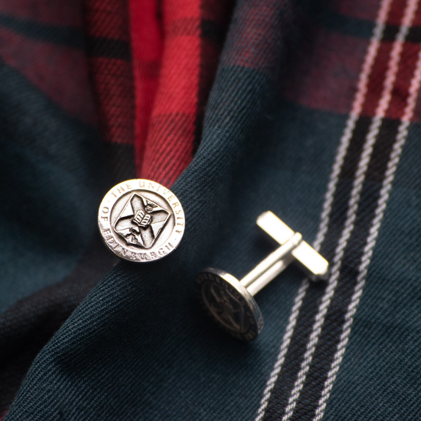 Our Silver University Crest Cufflinks on a University Tartan background.