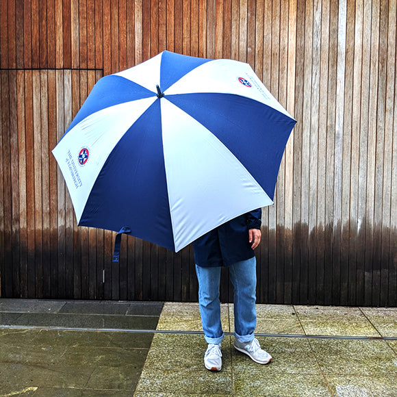 A model holding the large open umbrella. The umbrella is so large most of the model's body is hidden.