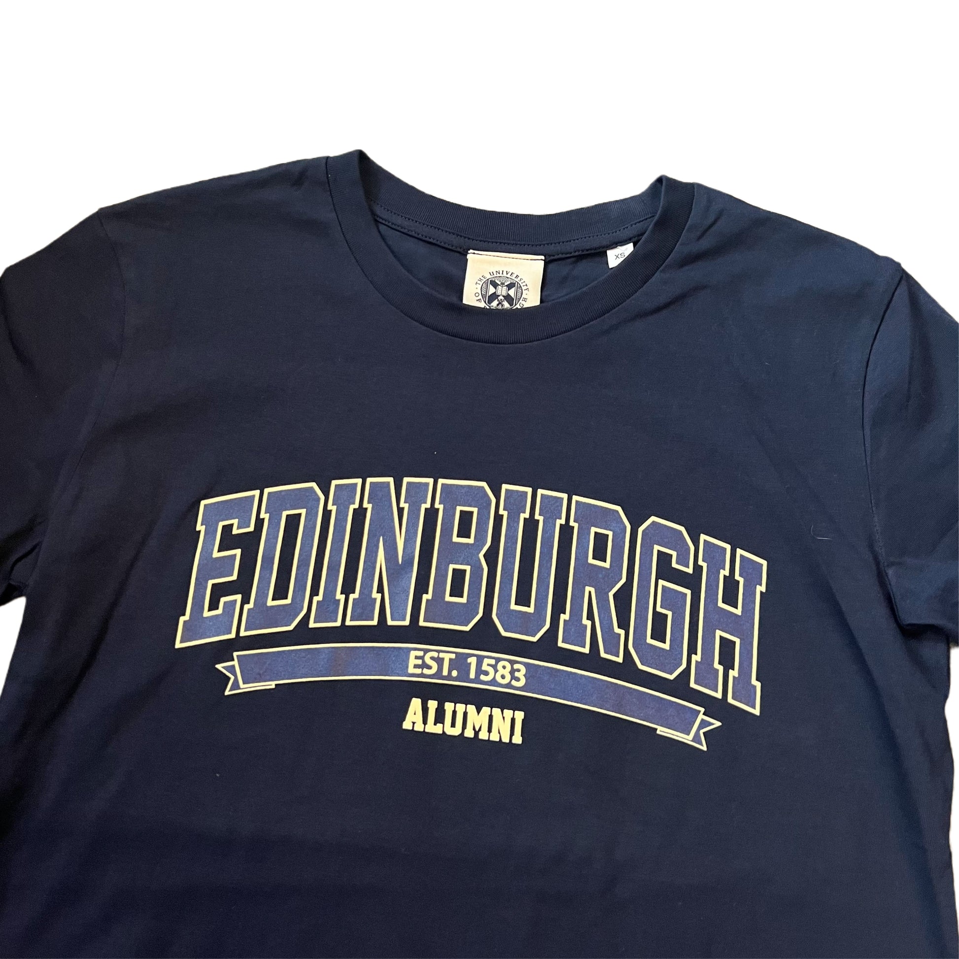 CLose up of Navy T-shirt with 'EDINBURGH ALUMNI' text on the front in a lighter blue color