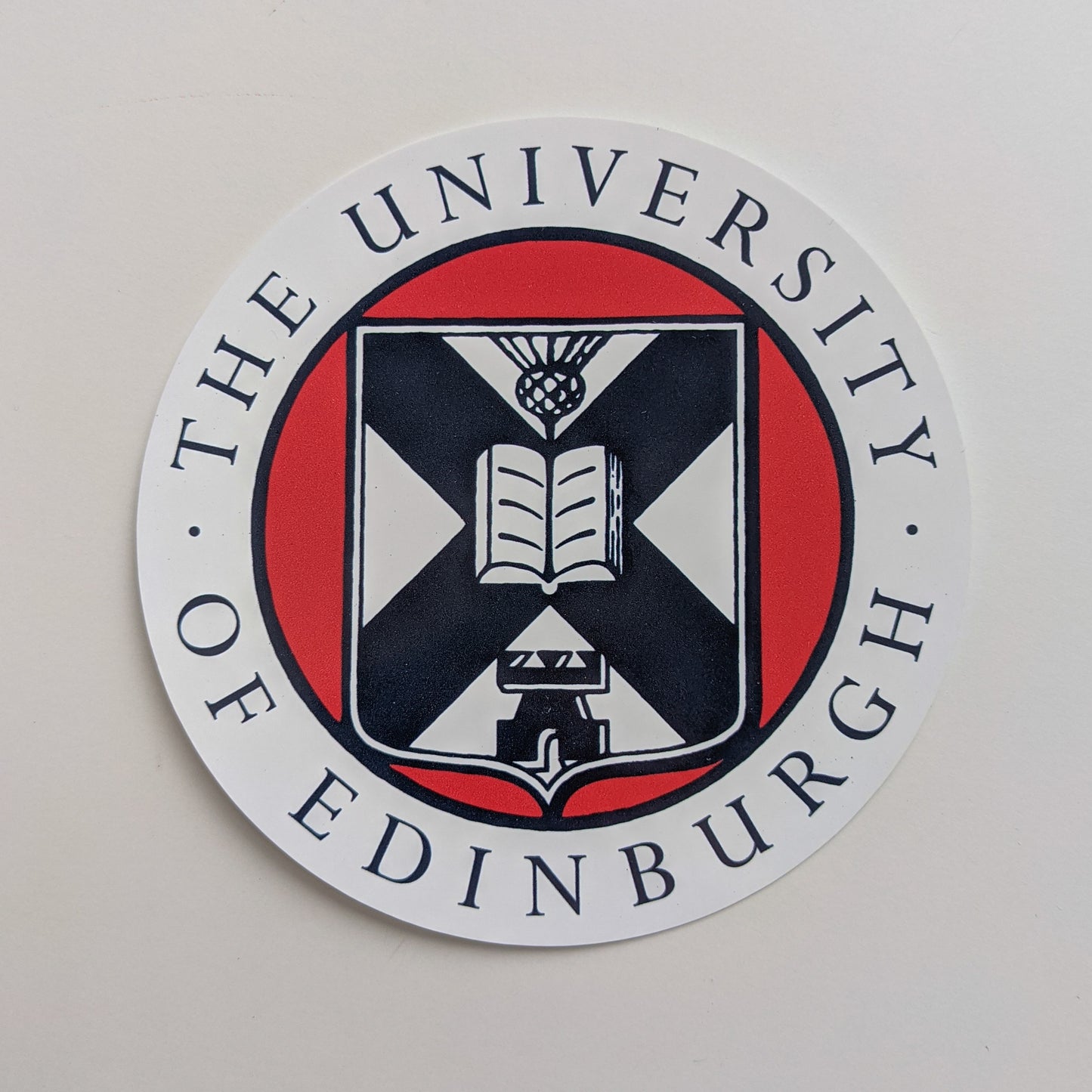 Circular sticker featuring the crest in full colour print.