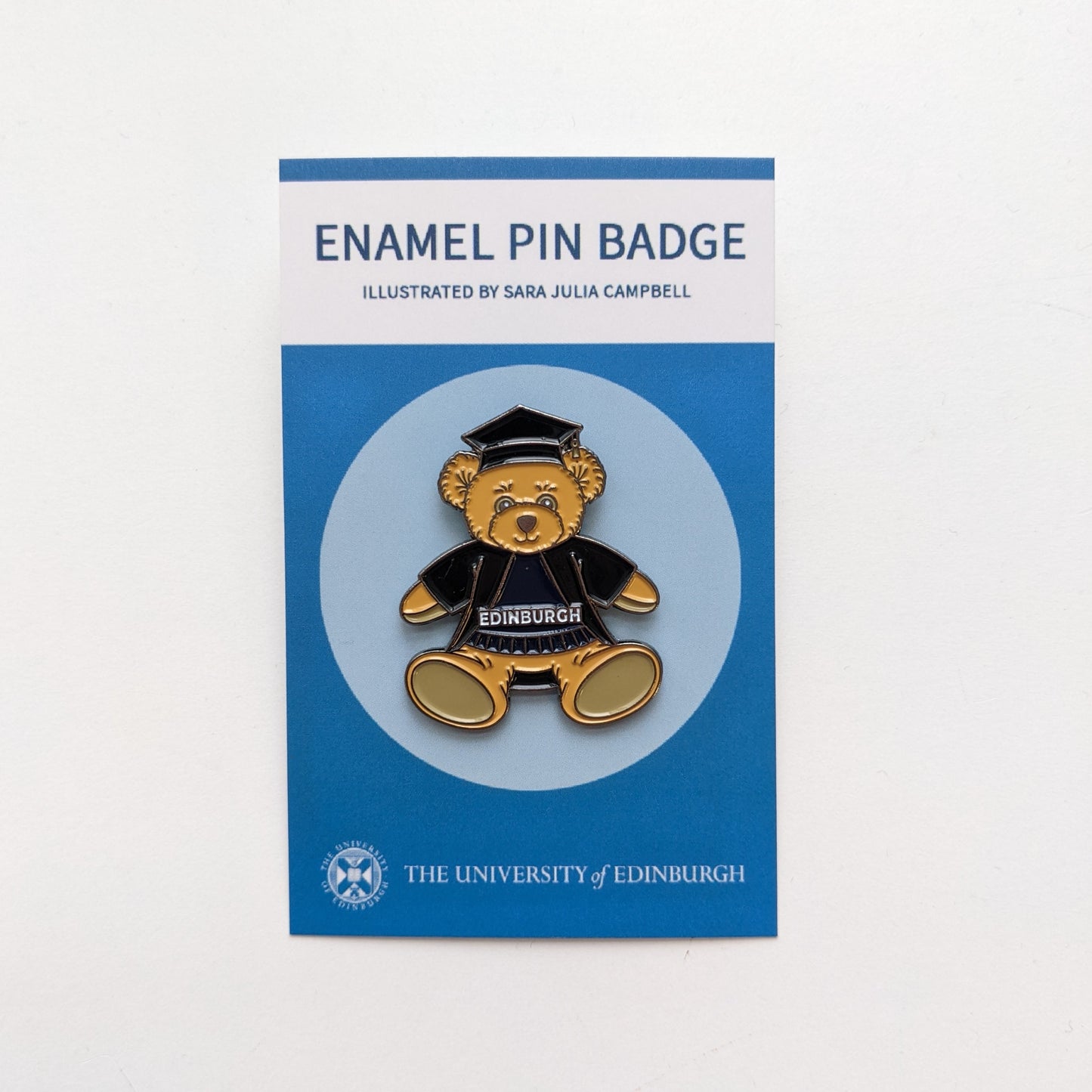 Full body plush bear pin with graduation gown and cap.