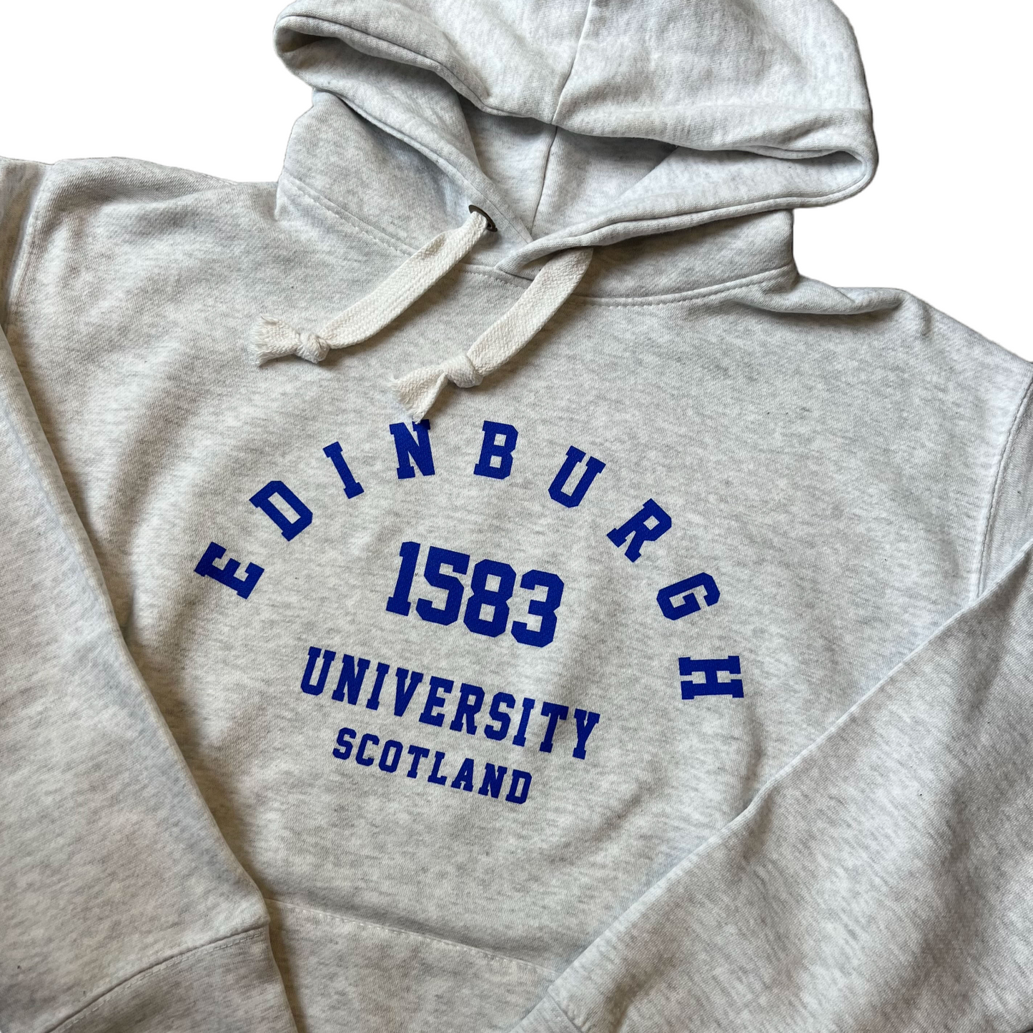 close up of Light Grey Hoodie with 'Edinburgh University 1583 Scotland' in royal blue print