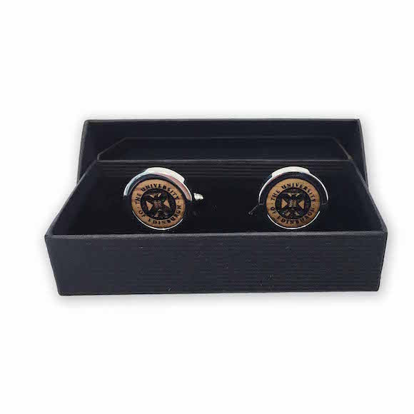Two Silver cufflinks featuring a whisky cask inlay and the Edinburgh University Crest in the centre.