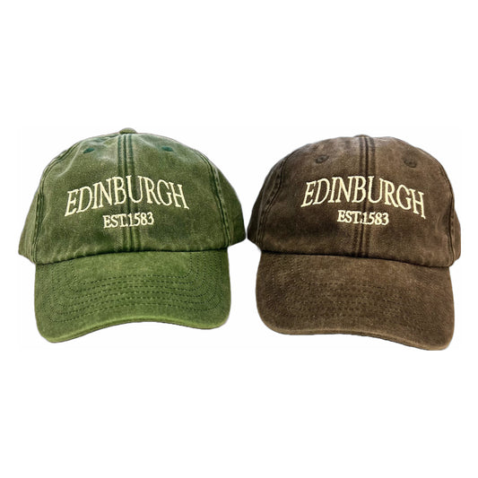Two baseball caps, one green and one black, both embroidered with the text 'EDINBURGH EST. 1583'