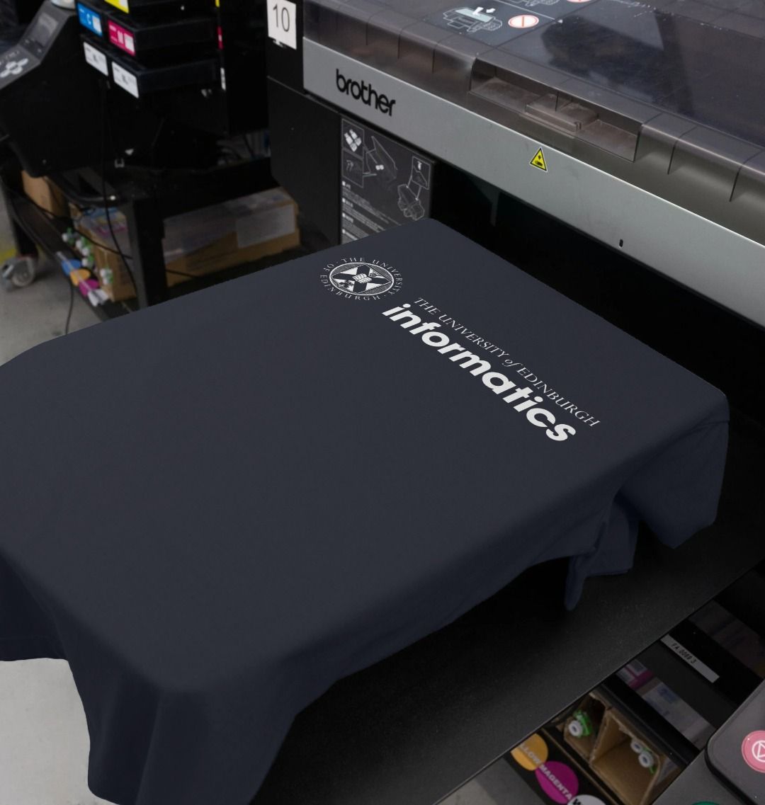 Our School of Informatics T Shirt being printed by our print on demand partner, teemill.