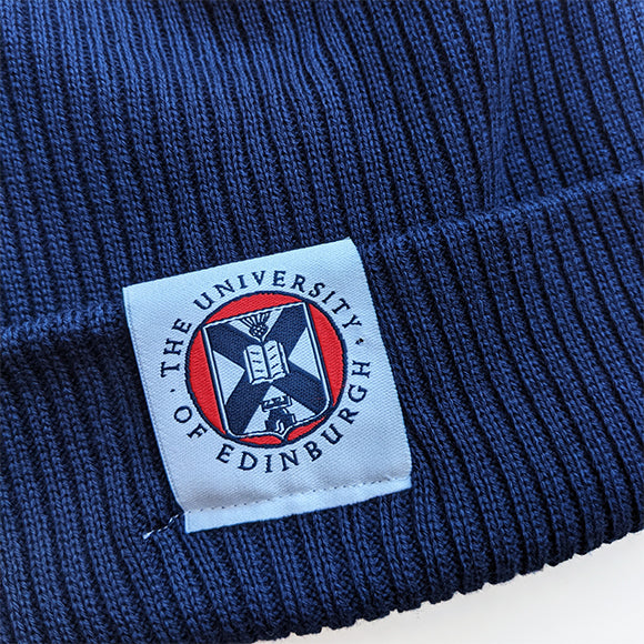 Close up of the embroidered label which has the University crest in full colour print.
