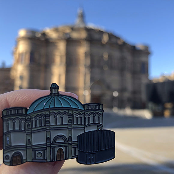 McEwan Hall Pin Badge held against McEwan Hall