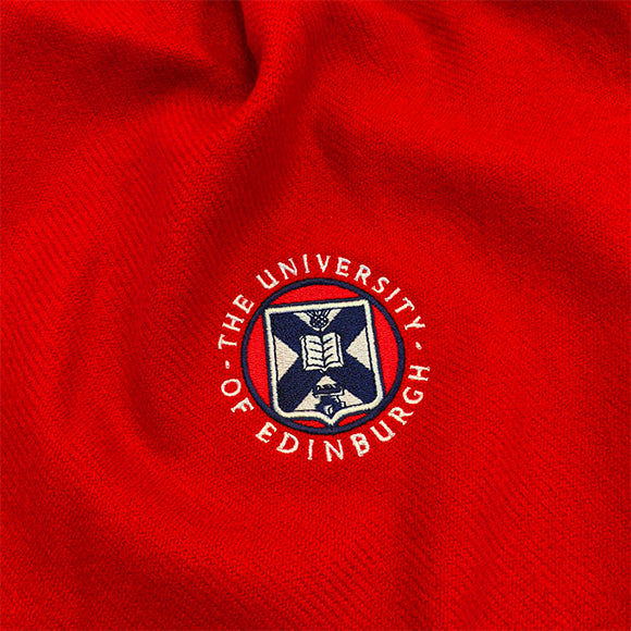 Close up of embroidered crest detailing.