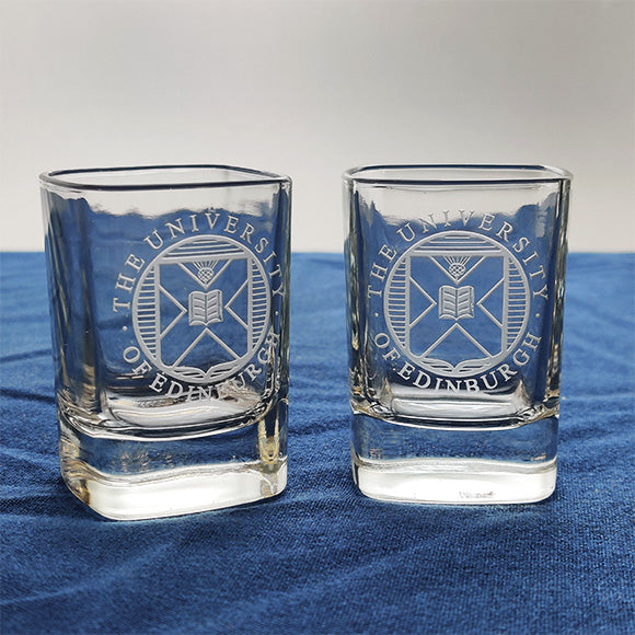 Two crystal shot glasses with University crest etching.