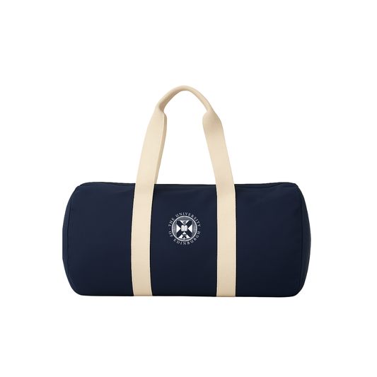 Navy barrel shaped canvas bag with cream handles. University crest is embroidered in the centre.