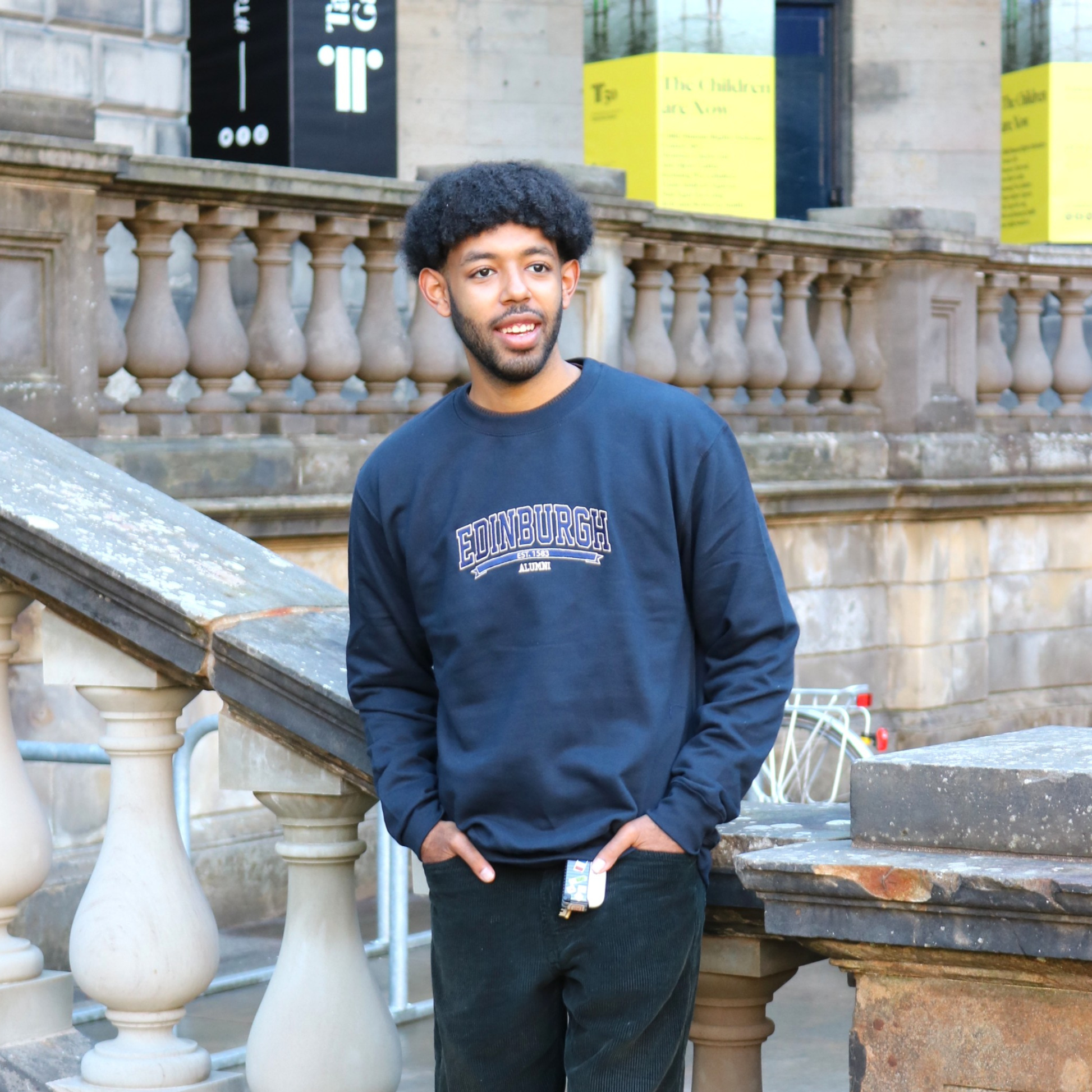Model wears Embroidered Alumni Sweatshirt in the Old College Quad.