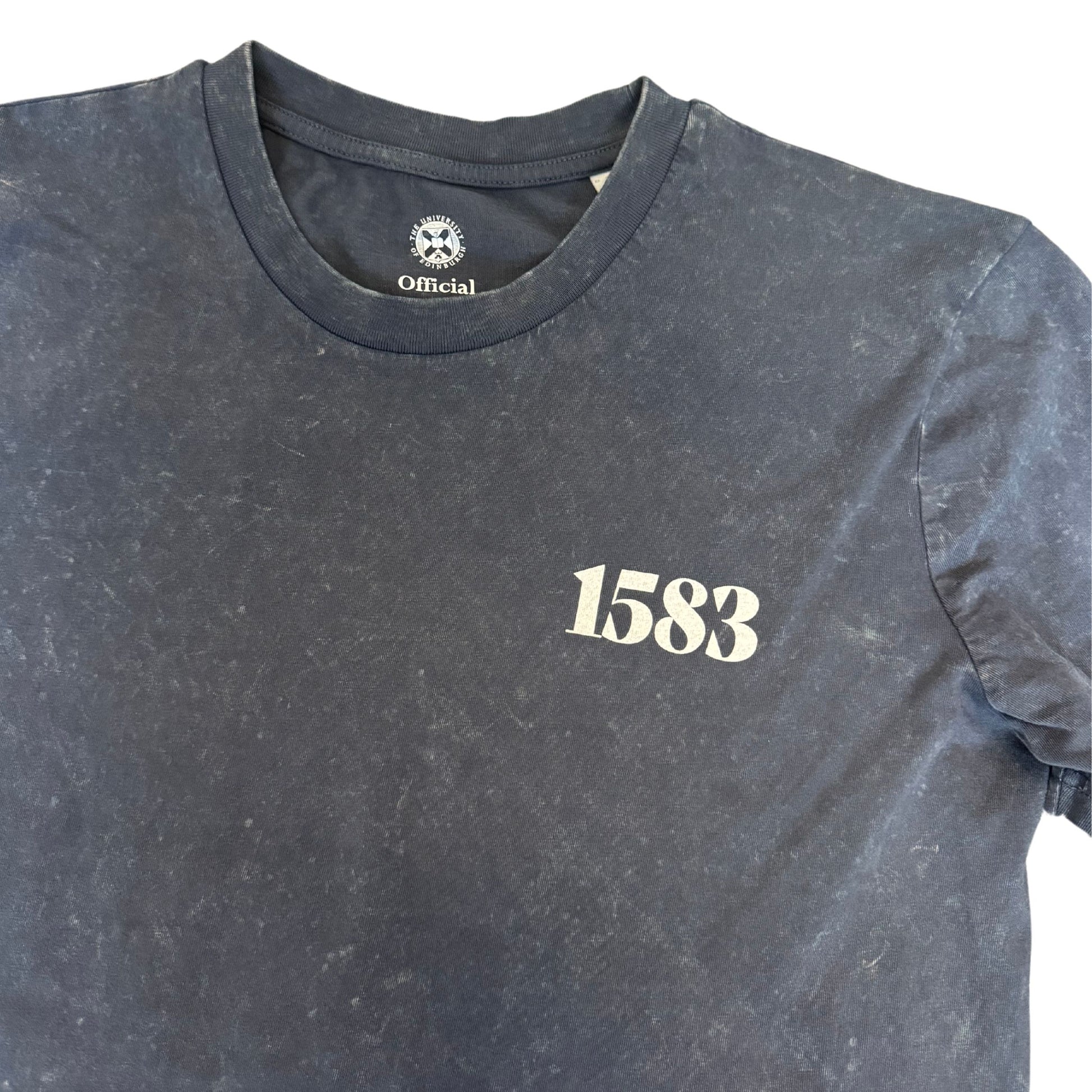 A close up of the distressed vintage t shirt showcasing the bubble text printed on the left chest, which says '1583' in a white bubble font.
