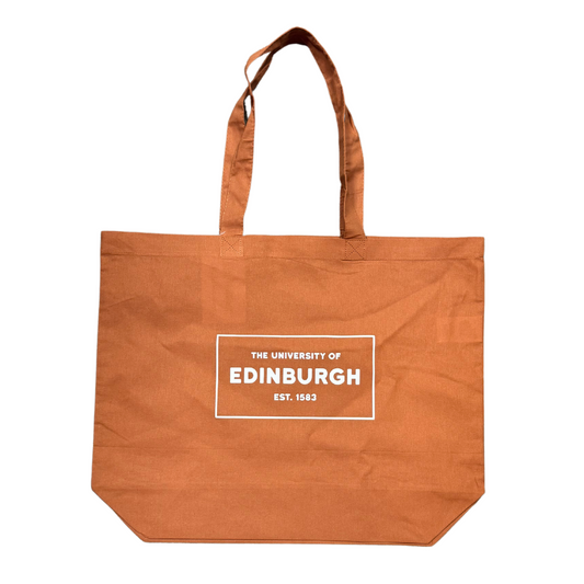 orange tote bag with a white box that says The University of Edinburgh est. 1583