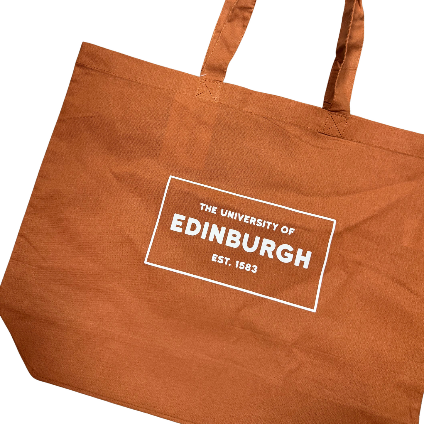 close-up of an orange tote bag with a white box that says The University of Edinburgh est. 1583
