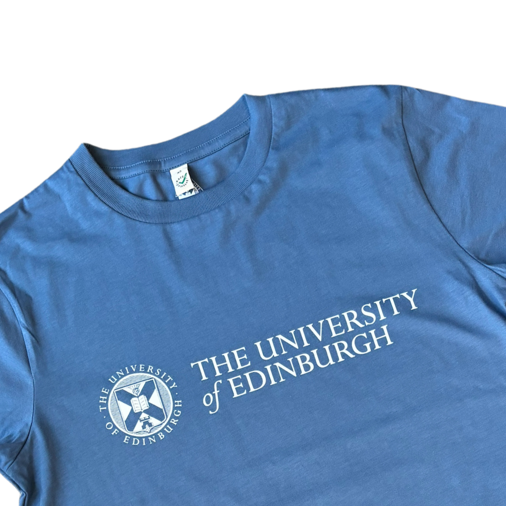 Close up of denim blue t-shirt with the University logo printed across the chest in white