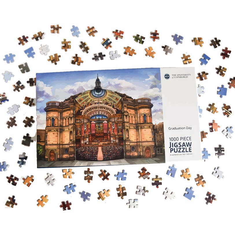 Image of the puzzle box with pieces scattered around. The puzzle design is McEwan Hall - artistic interpretation of inner and external views of the building. 