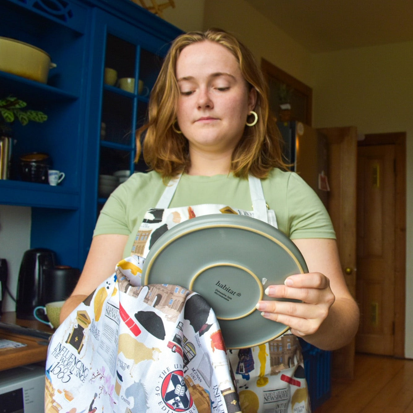 Model wears Heritage Collection Apron and uses Heritage Collection Tea Towel.