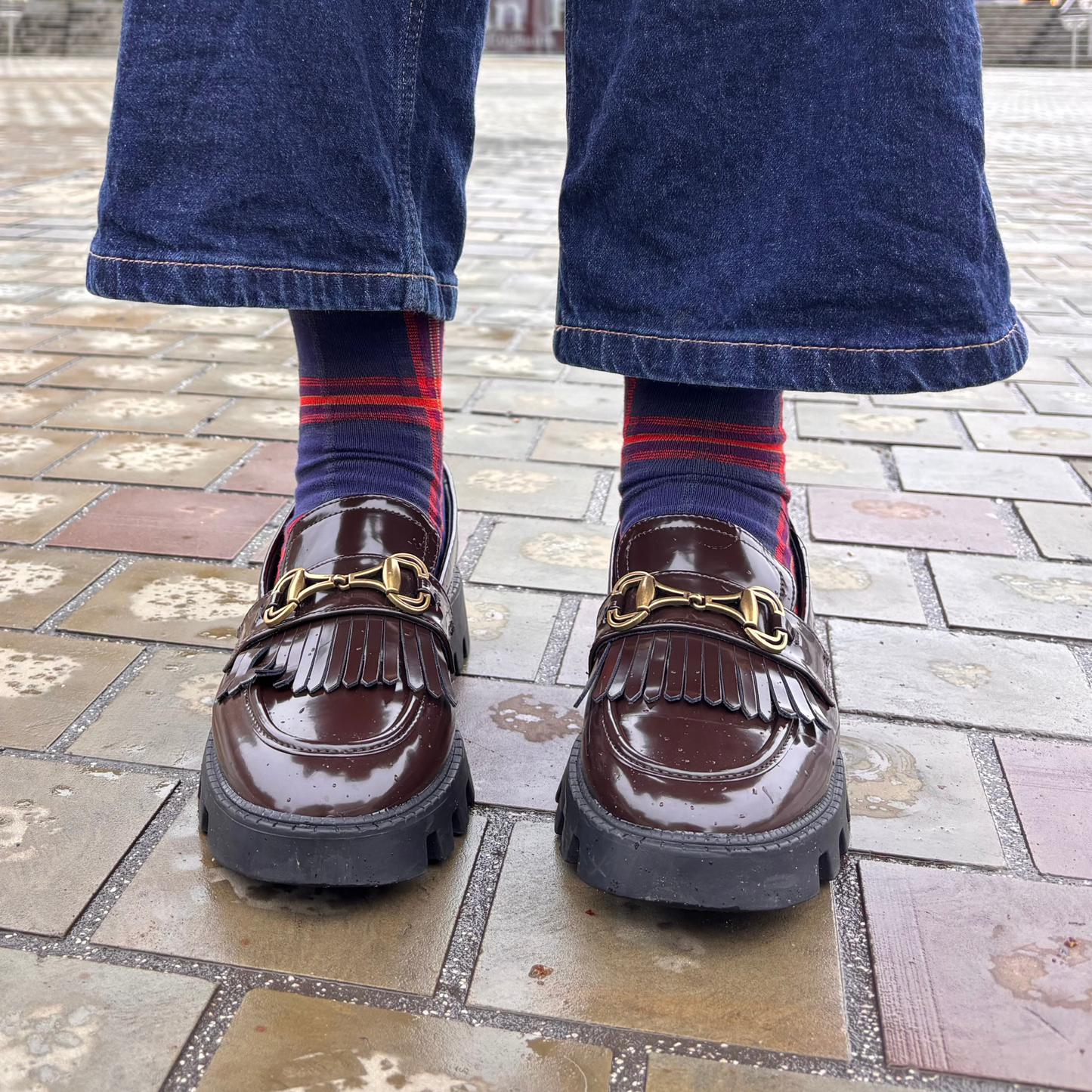 Brown loafers with gold buckles worn with Edinburgh Medical School tartan socks in Bristo Square