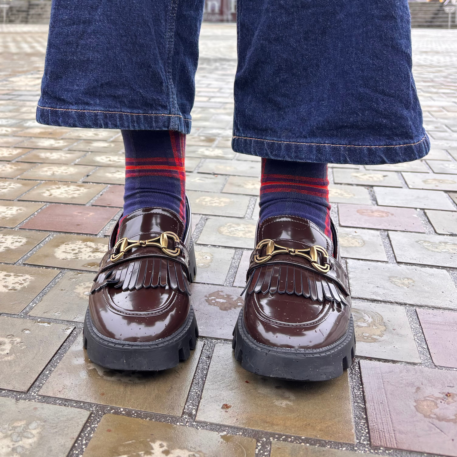 Brown loafers with gold buckles worn with Edinburgh Medical School tartan socks in Bristo Square